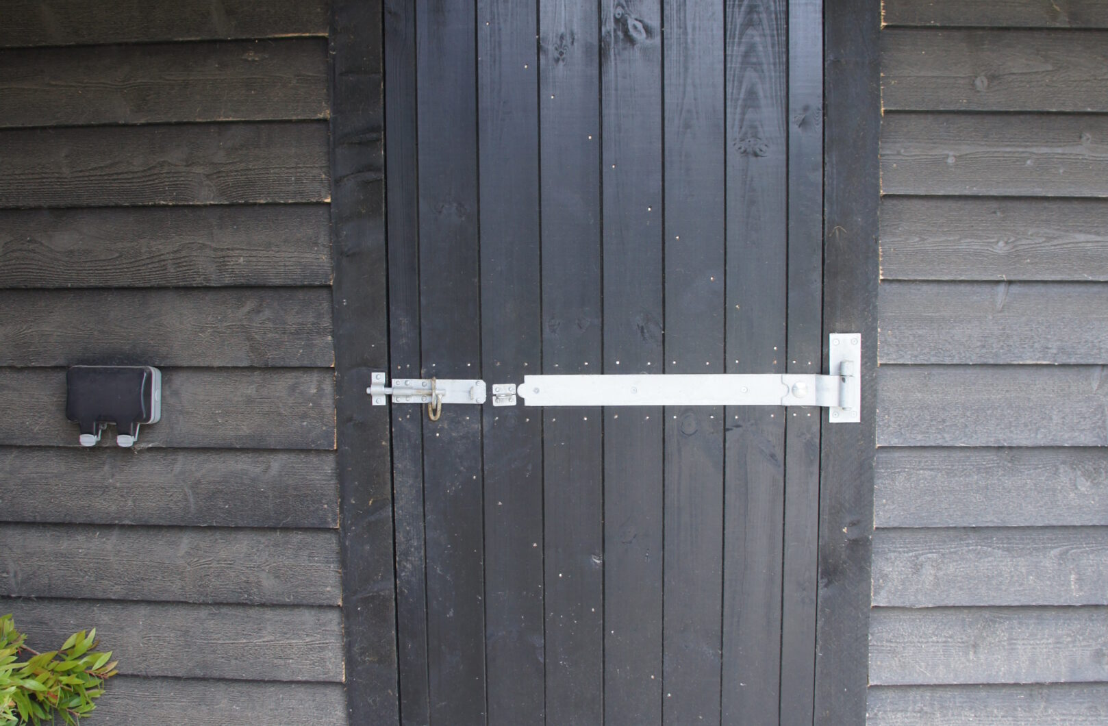 Black tack room door on featheredge building