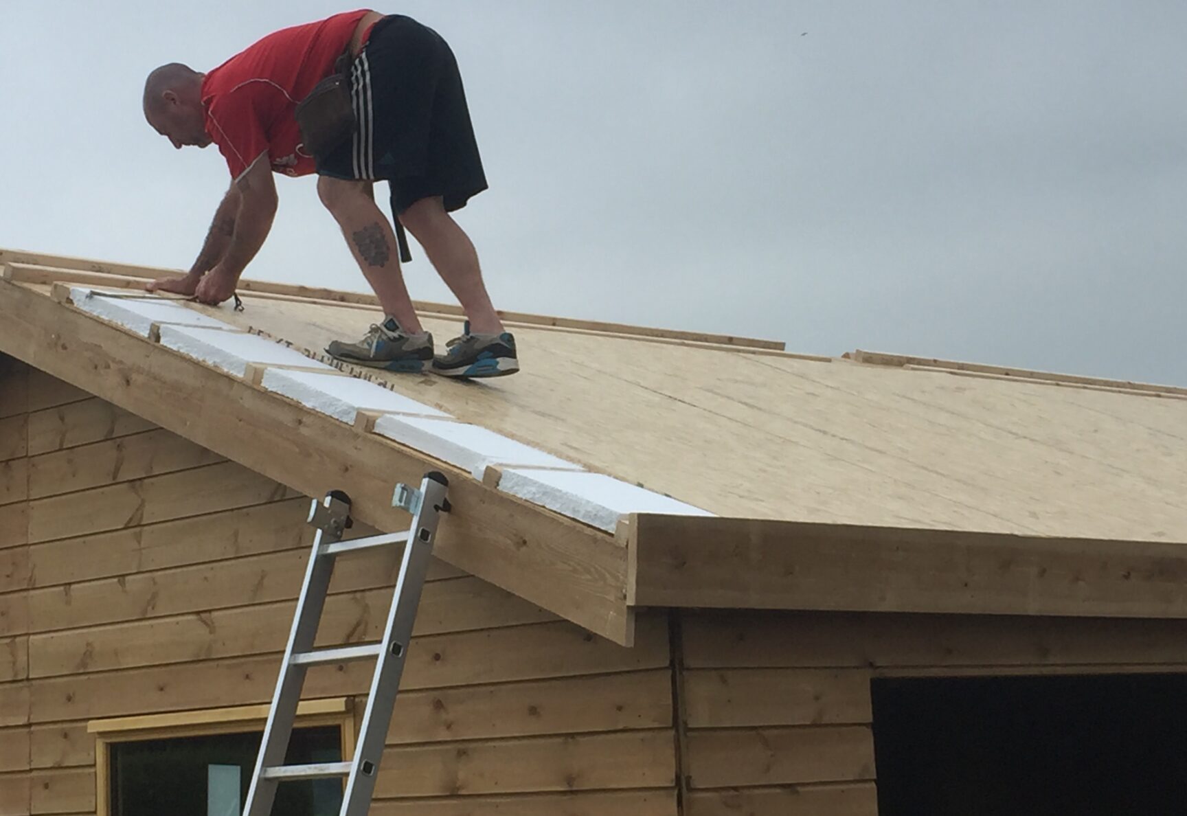 Crafstman on roof measuring