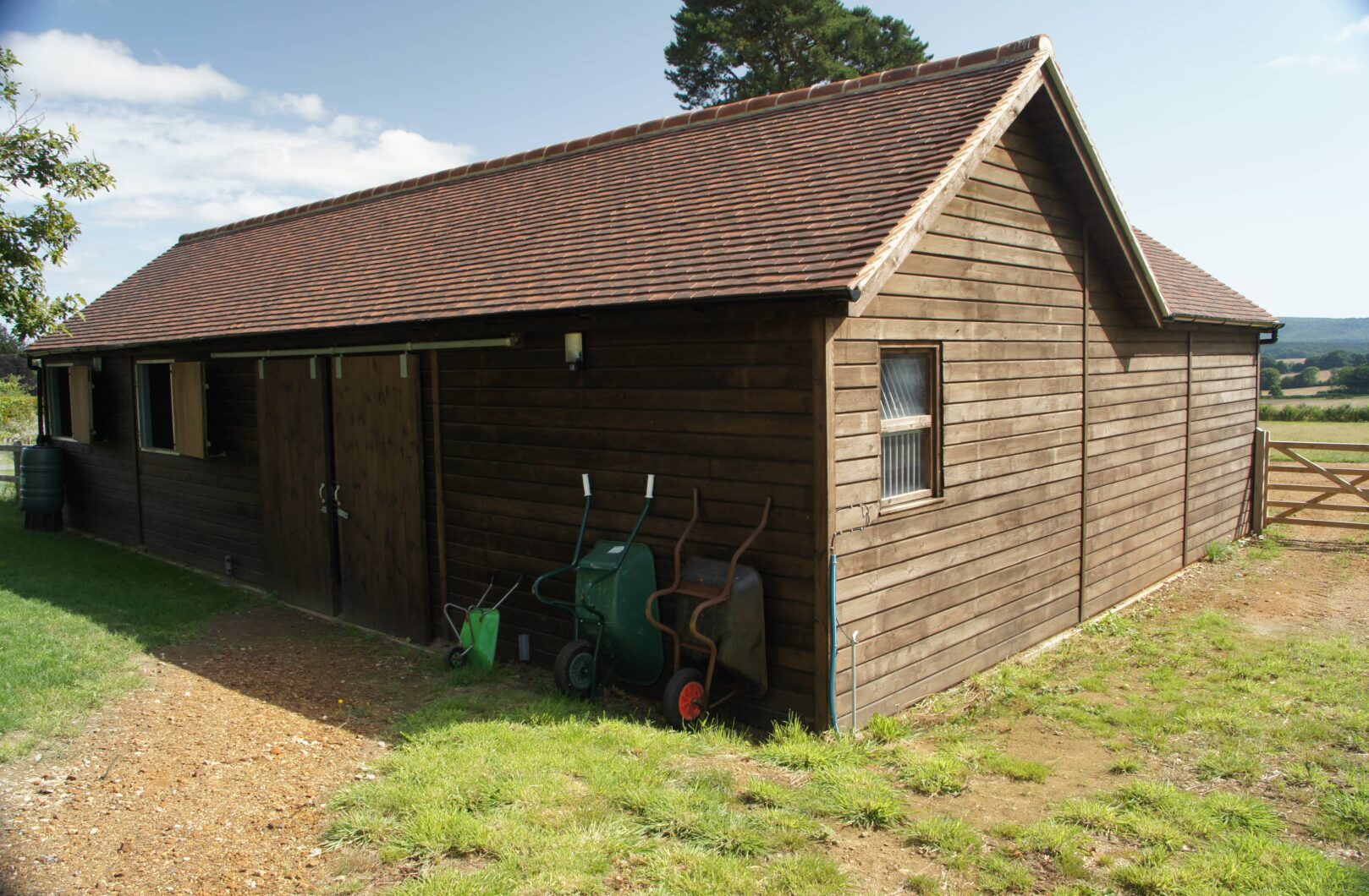 Brown L-shape stable block with clay tiles back side