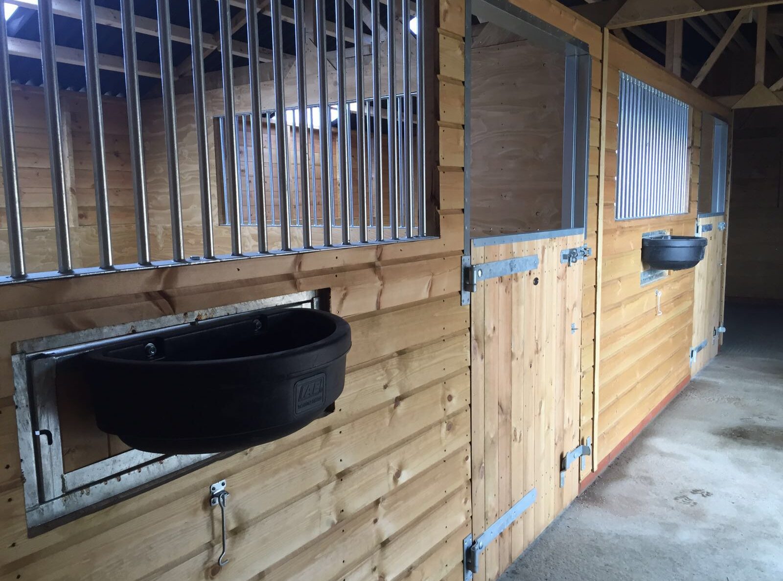 internal stables inside the american barn, swivel feeders face towards the passageway
