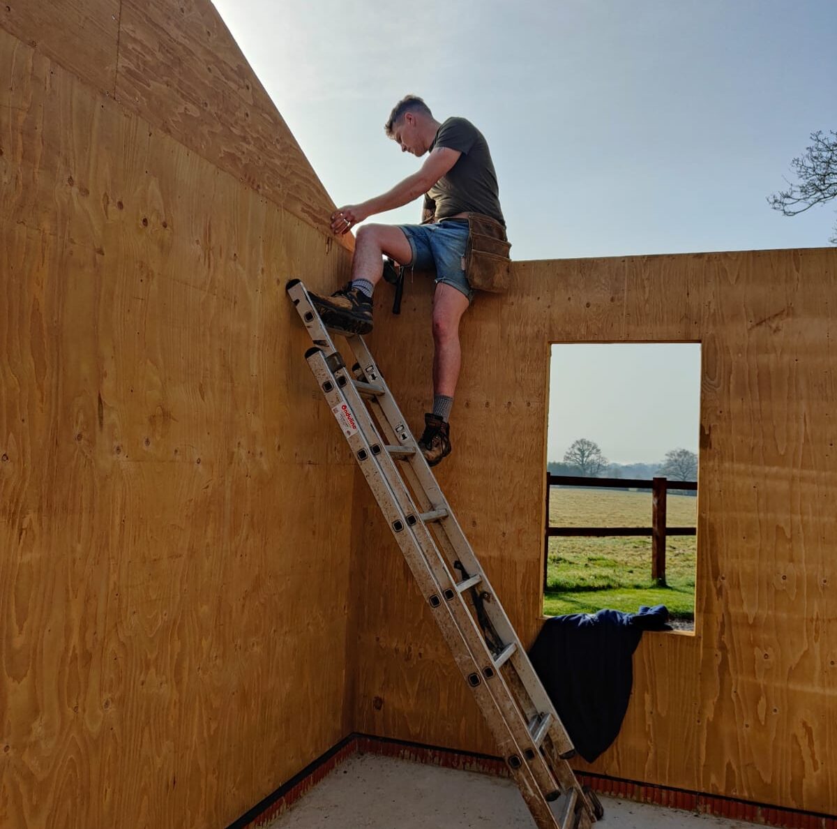 Crafstman installing truss on ladder