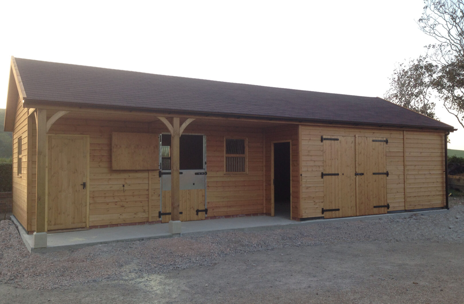 Brown felt shingle on straight run stable block with black ironmongery