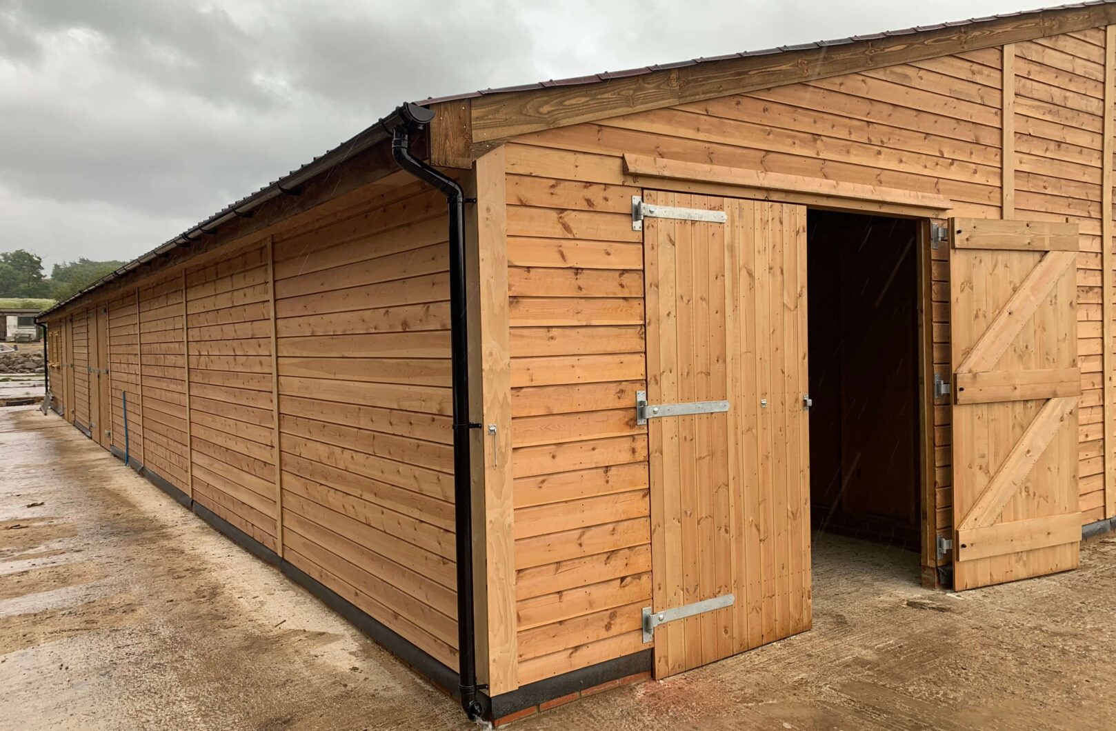 Double doors, one side is open going into the american barn