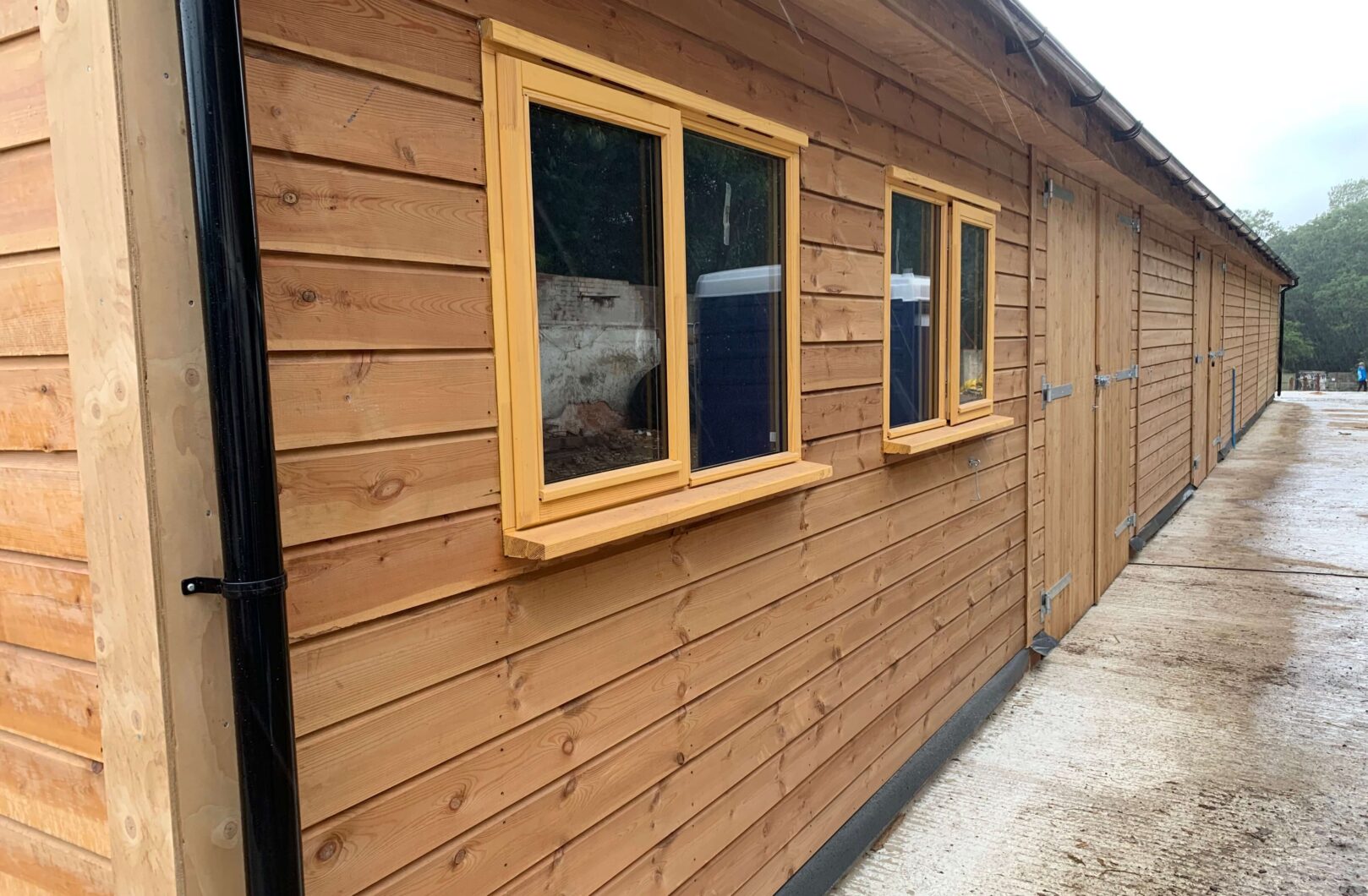 Two casement windows and a double door and sliding door further along the wall. Situated on the gable end of the american barn.