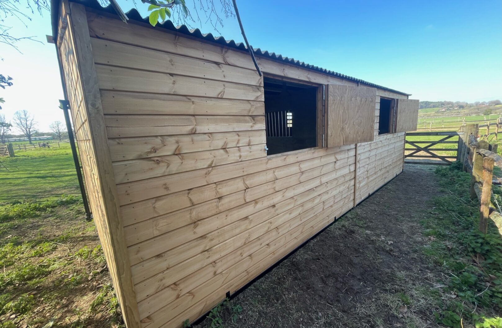 Rear of double mobile stable with rear stable doors open and pinned back