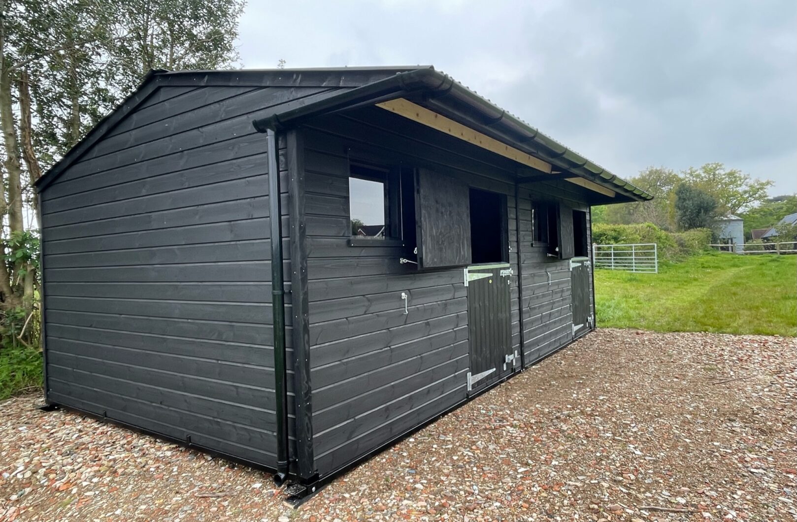 Double mobile stable painted black with top doors open