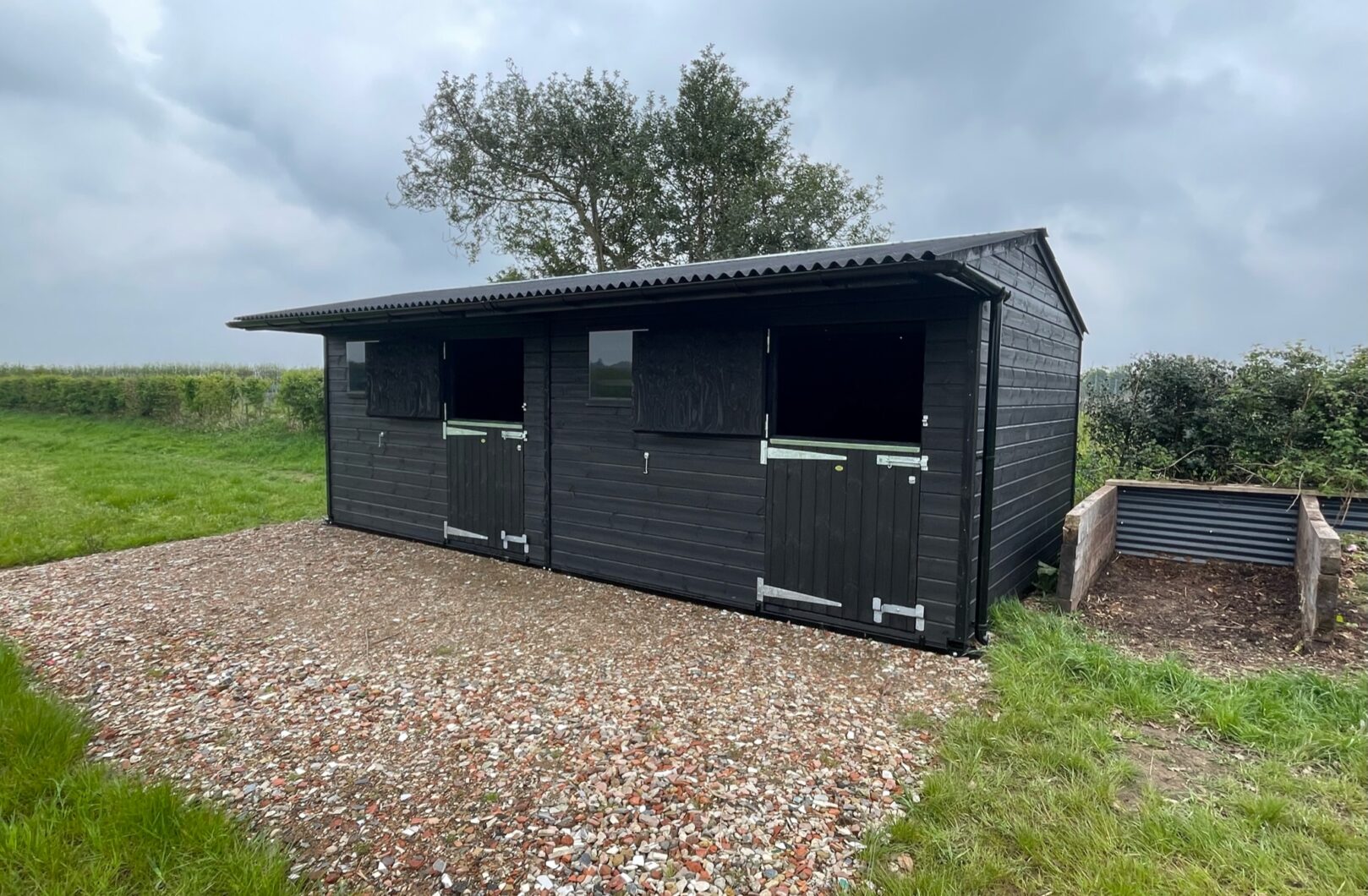 Double mobile stable painted black viewing from the front