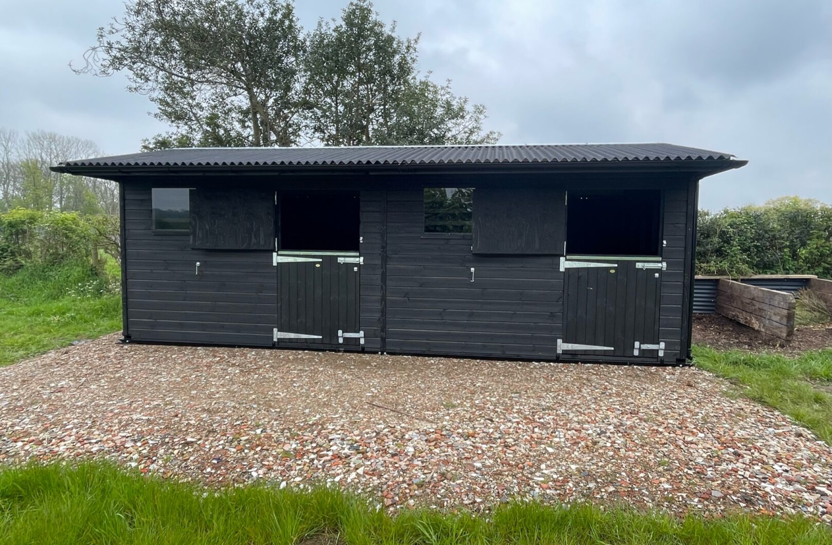Double mobile stable painted black front on with top doors open