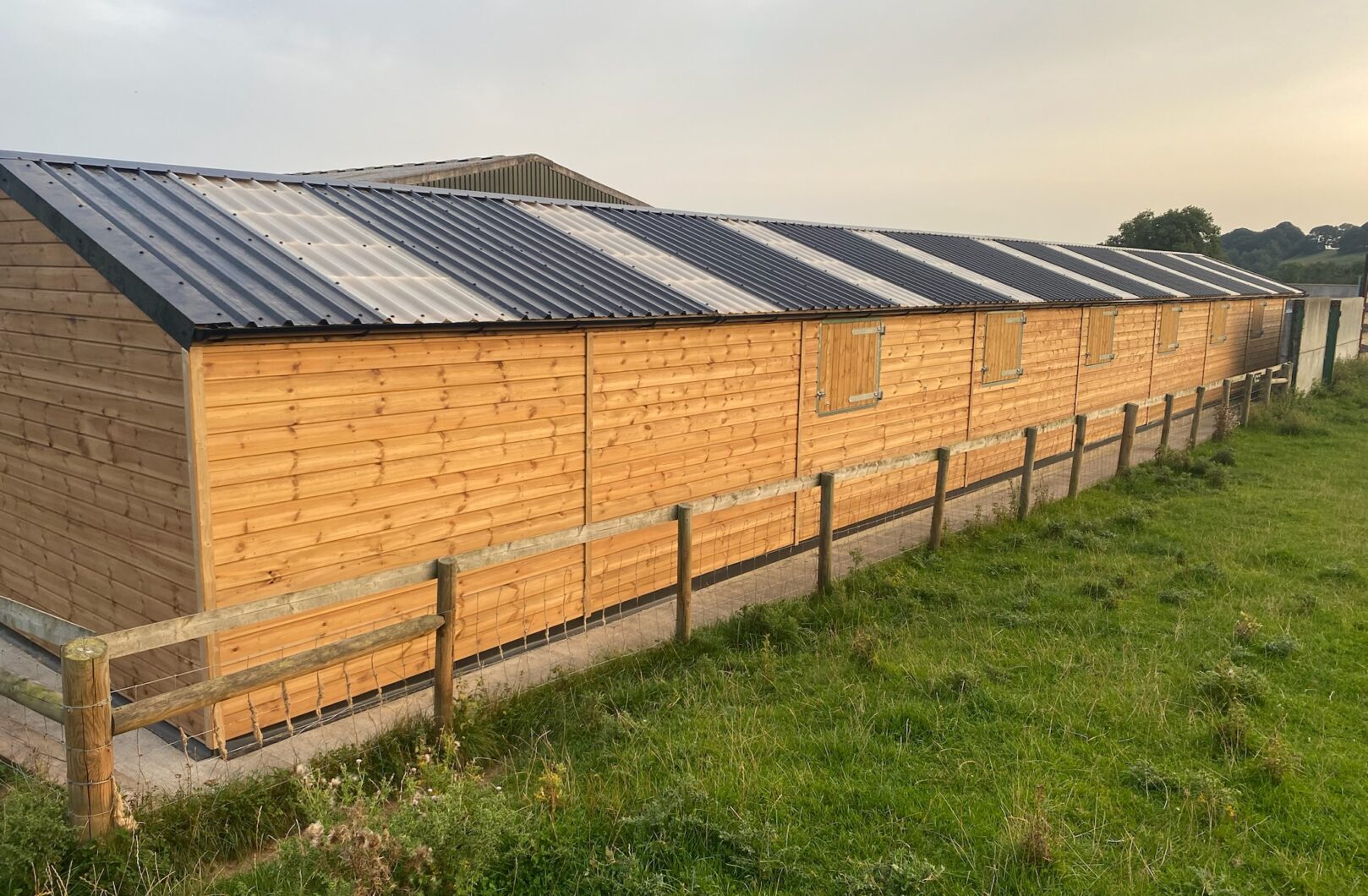 Back of building with metal box profile roof and clear roof sheets