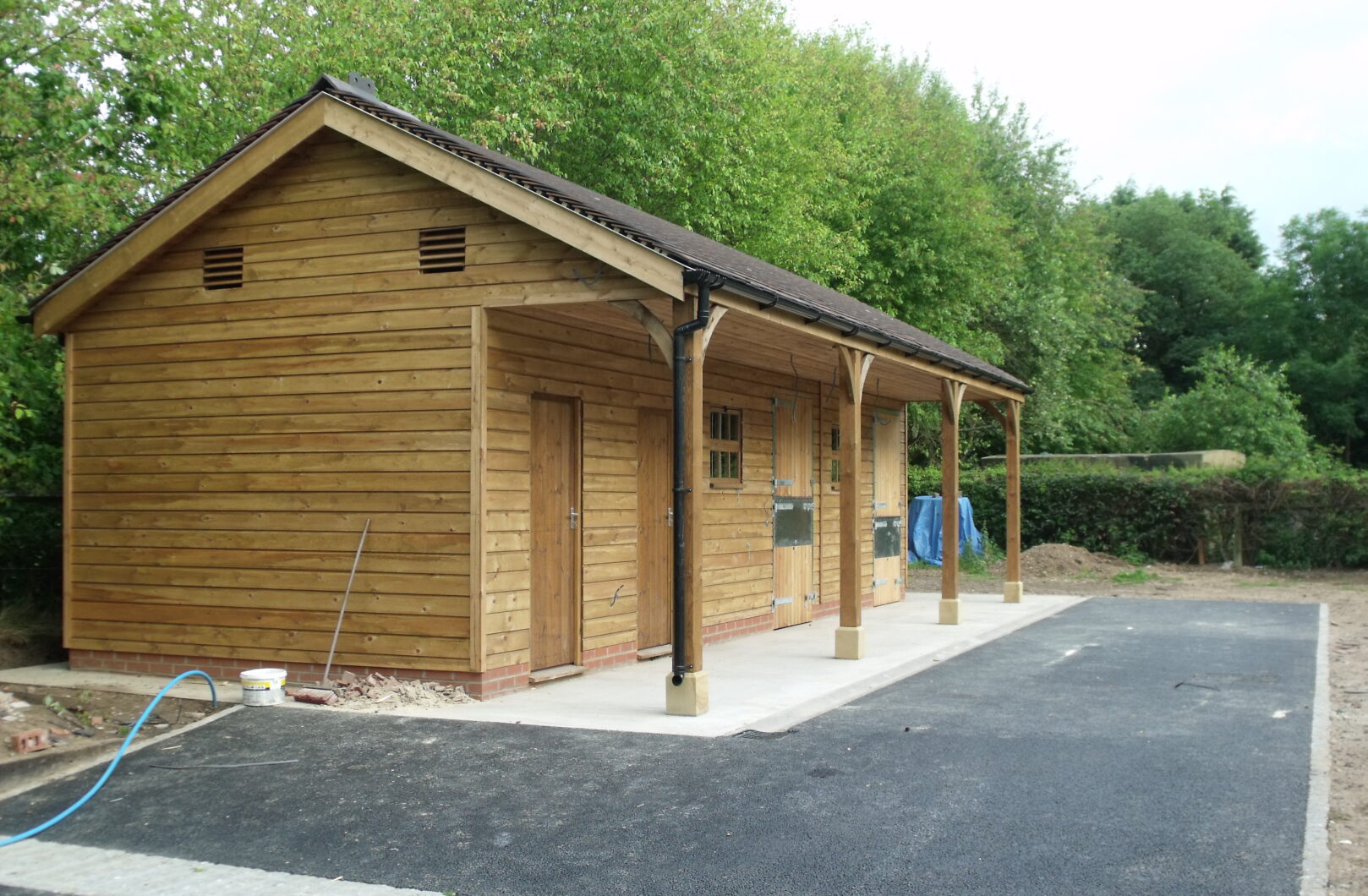side on stable block with support posts and clay tiles