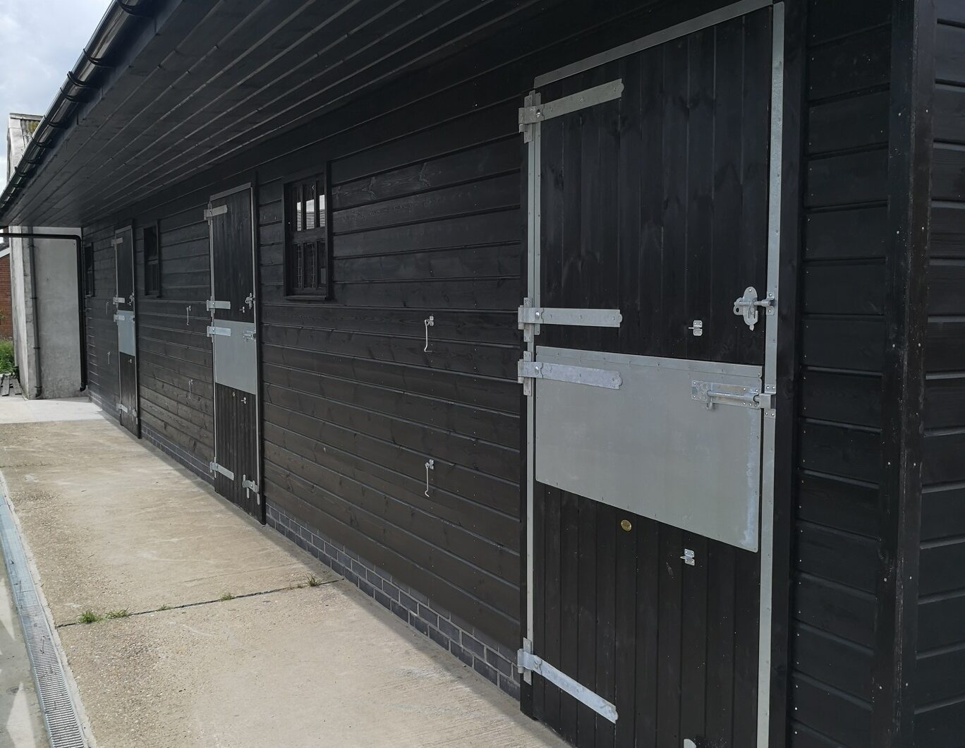 Black stable with extra deep door frame protection and silver ironmongery