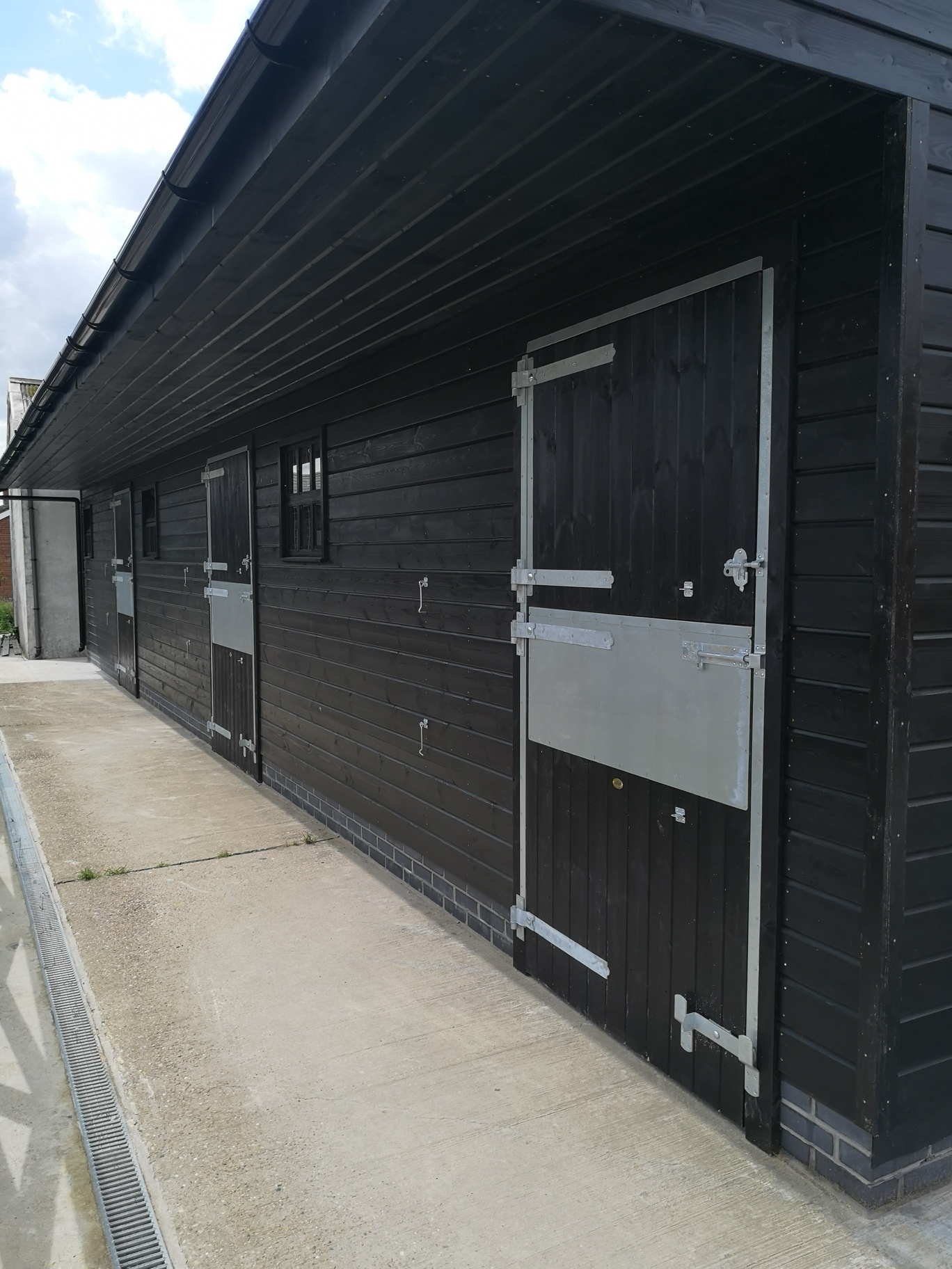 Black stable with extra deep door frame protection and silver ironmongery