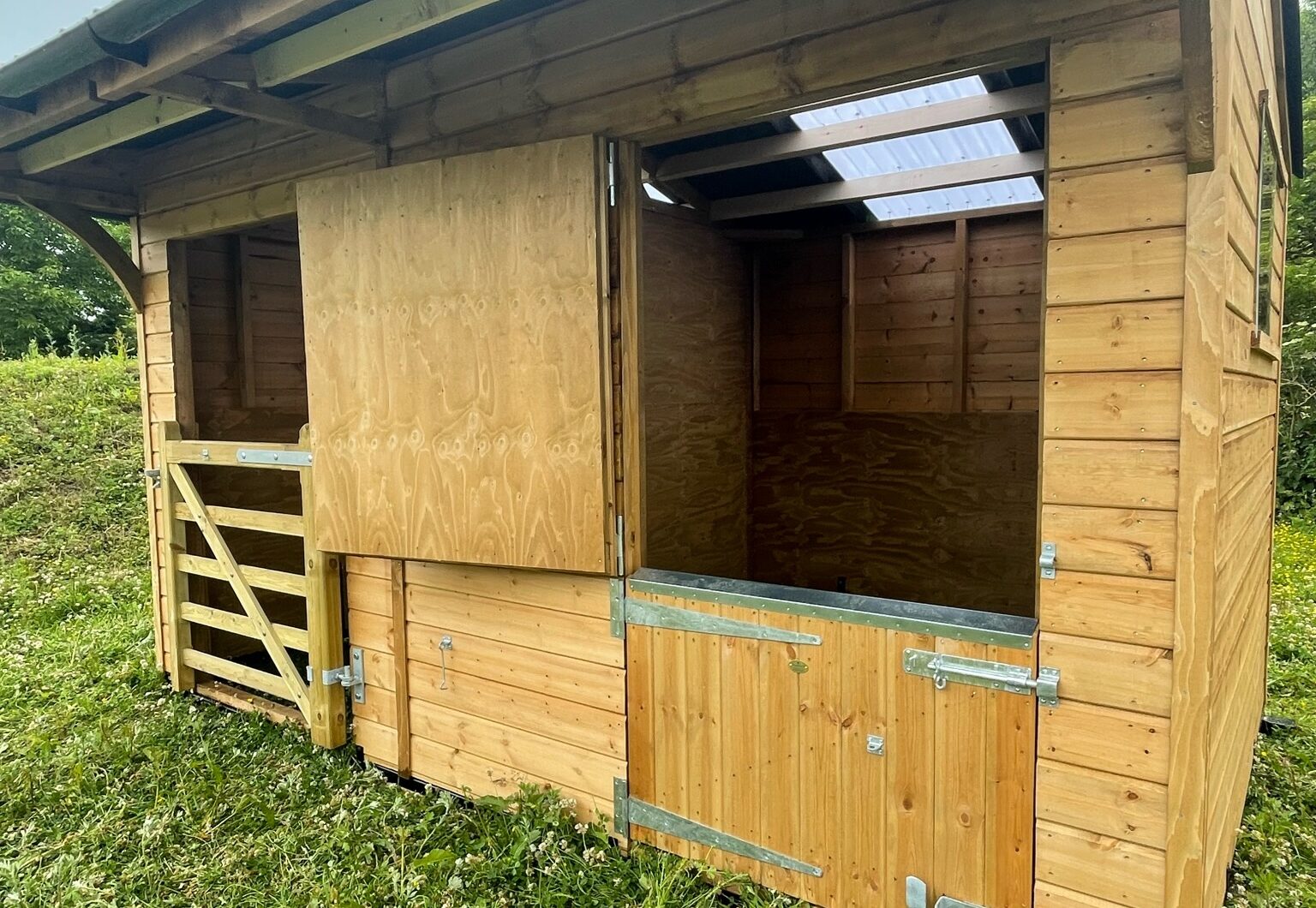 Dinkey donkey stable in paddock, top door open close up