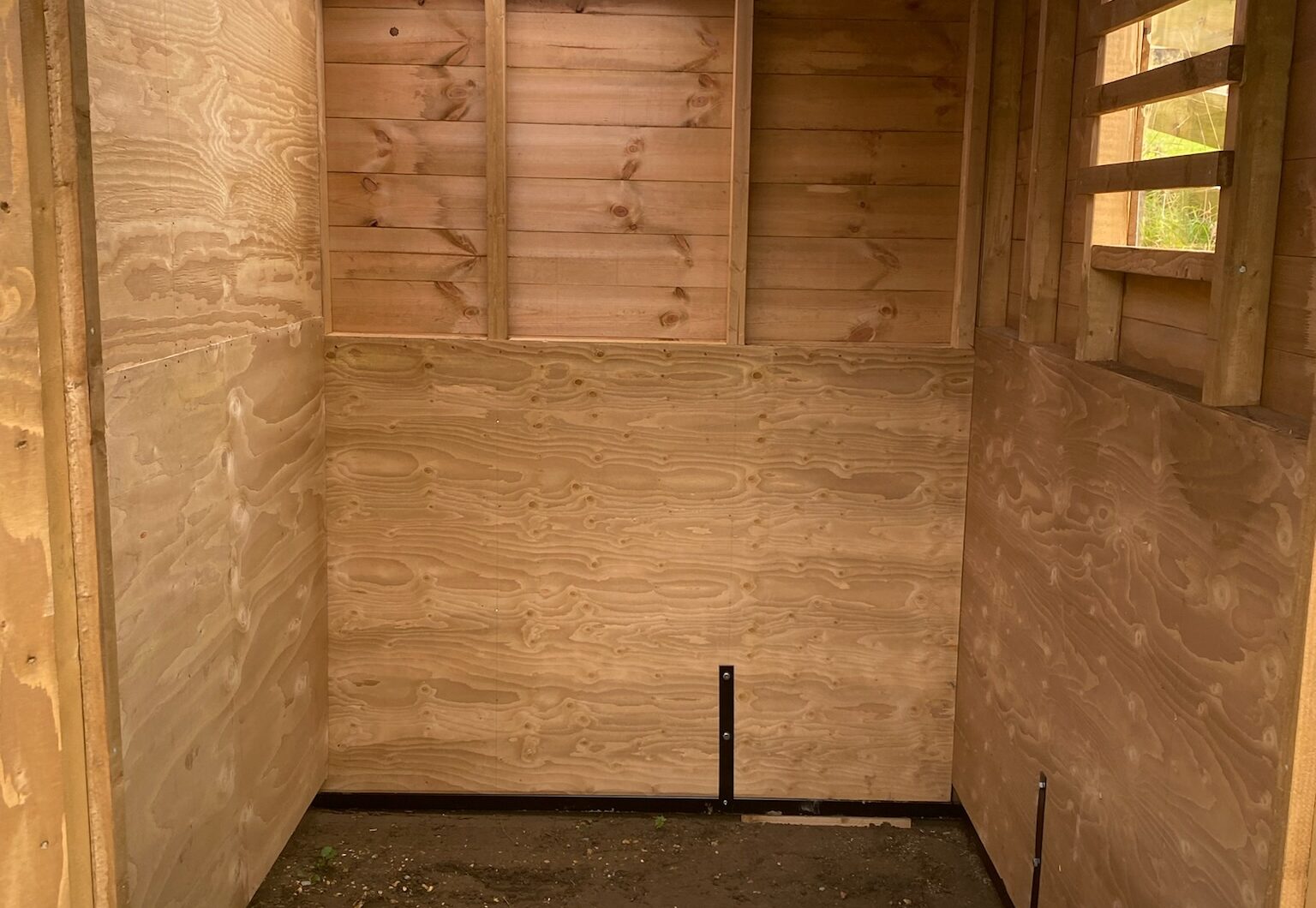 Dinkey donkey stable interior, kickboarded to 1.2m in wisa spruce, clear roof sheet and sliding perspex window