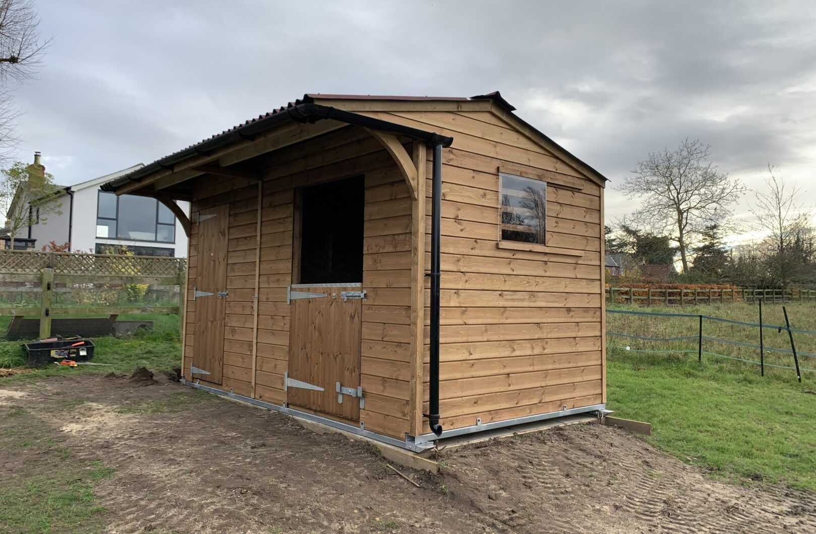 Dinkey donkey stable in paddock, doors closed and sliding perspex window on gable end