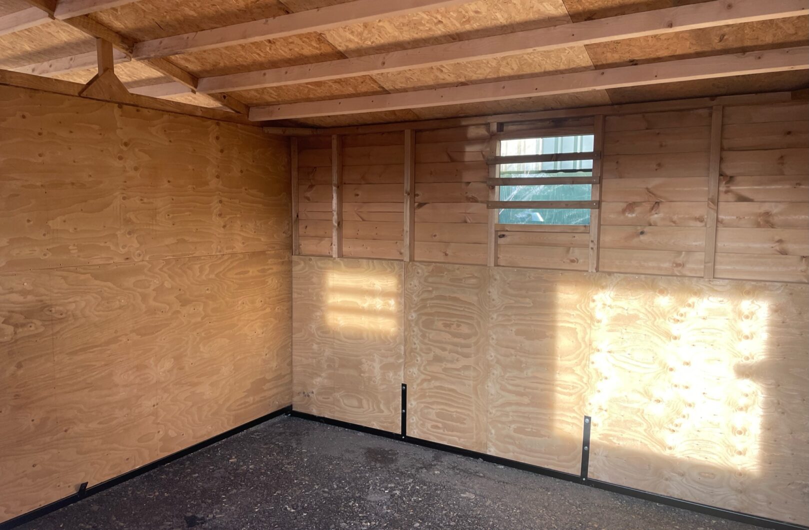 Interior of a triple mobile field shelter, kickboarded to 1.2m high, a sliding perspex window is on the back side of the building