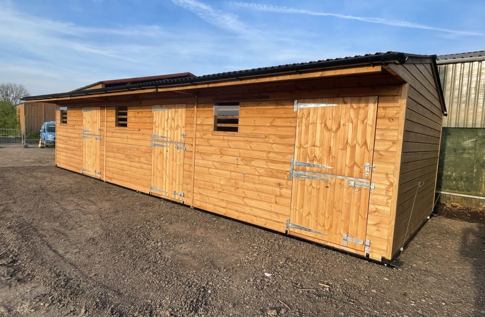 Triple mobile stable with 2 full stable doors and a full pony door, doors closed.