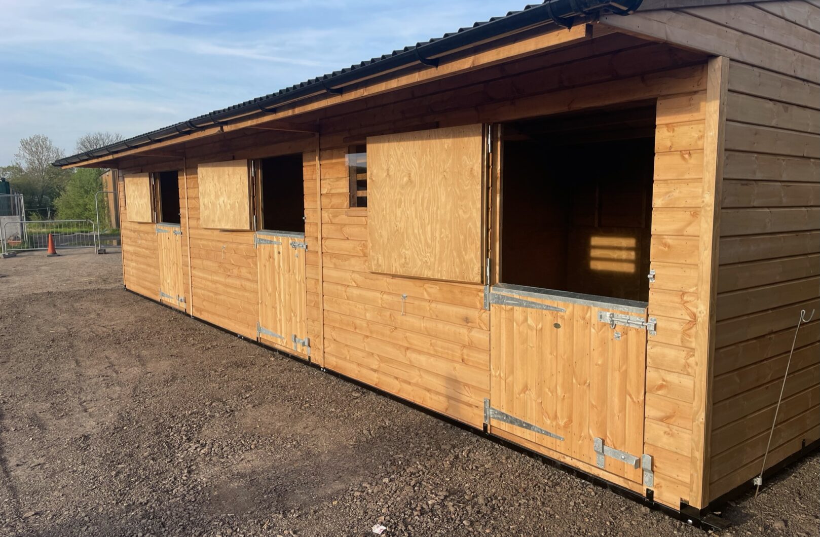 Triple mobile stable with top doors open. 2 full stable doors and a pony door (smaller bottom door).