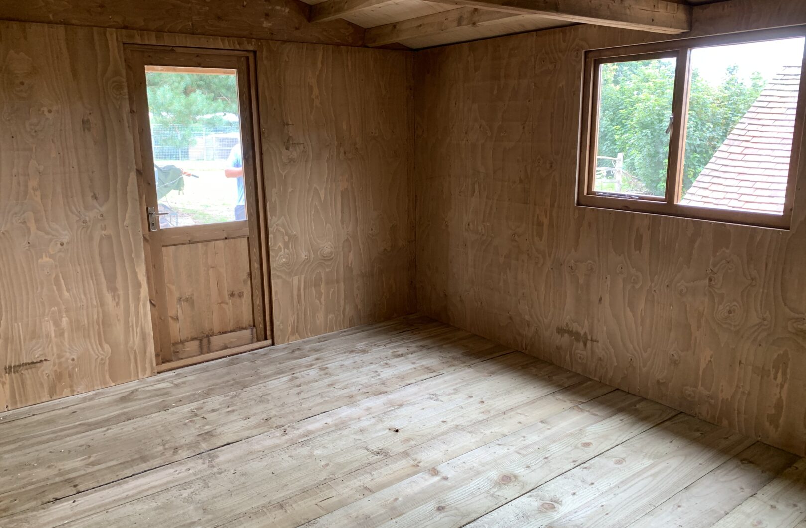 Internal of garden office with casement windows and timber floor