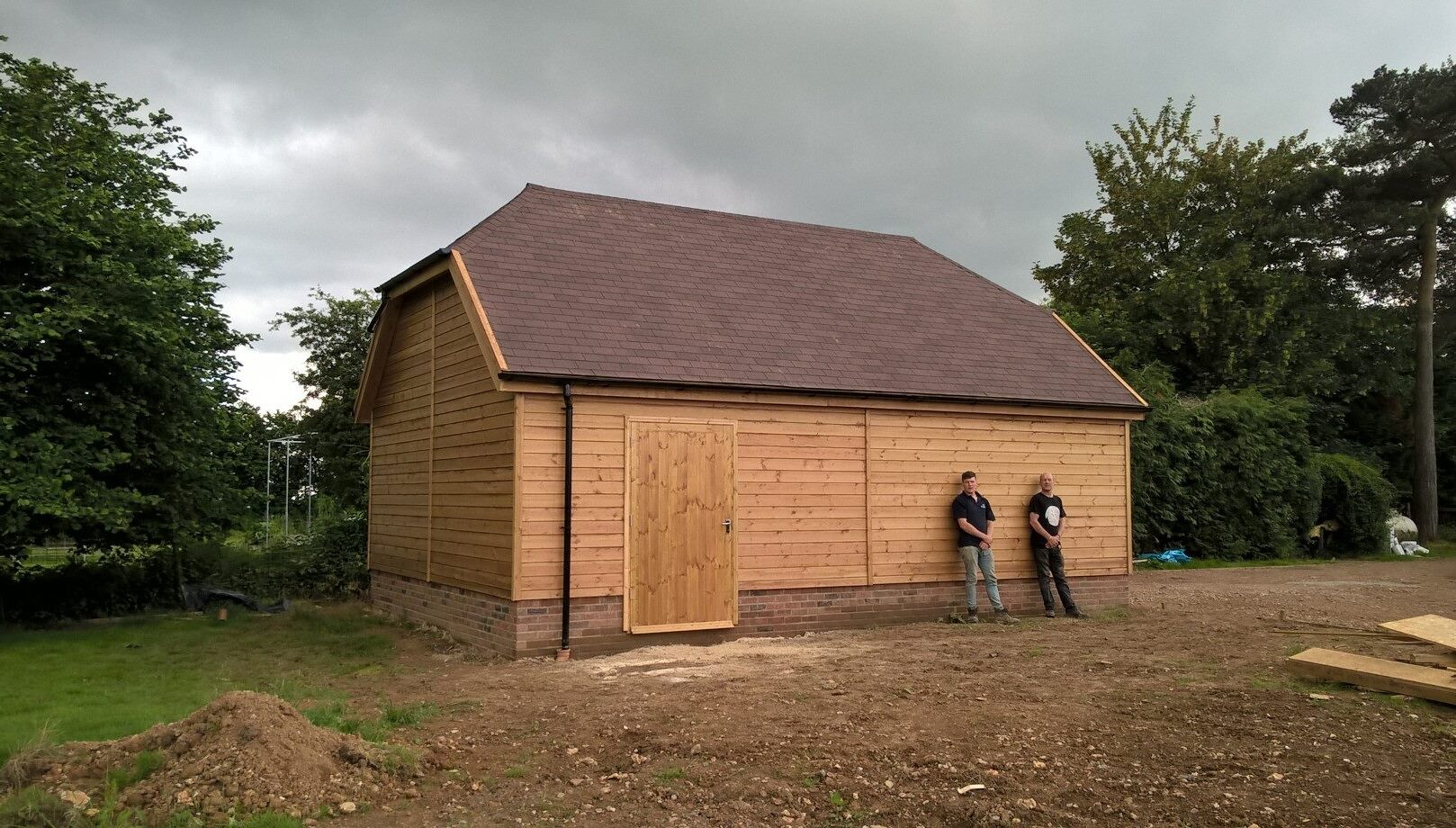 Hip Barn Roof Garage with craftsmen out front