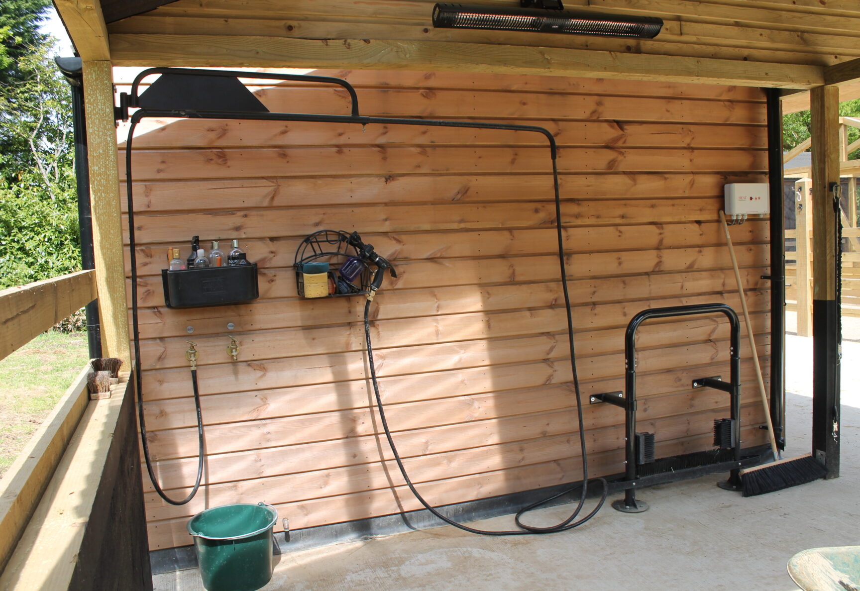 Washdown equipment hanging from side of stables